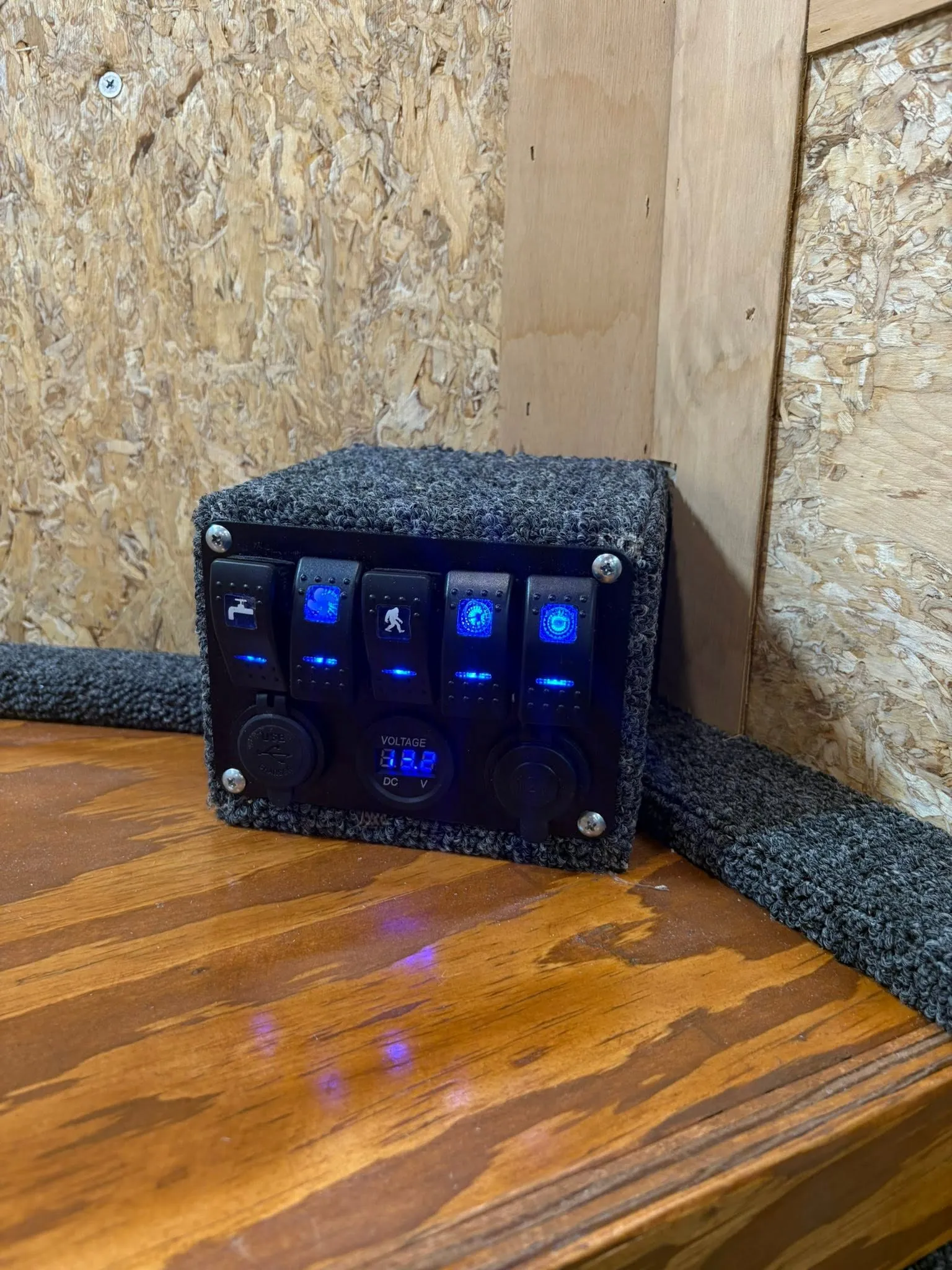 12V switch panel with USB and 12V outlets and a voltage readout.