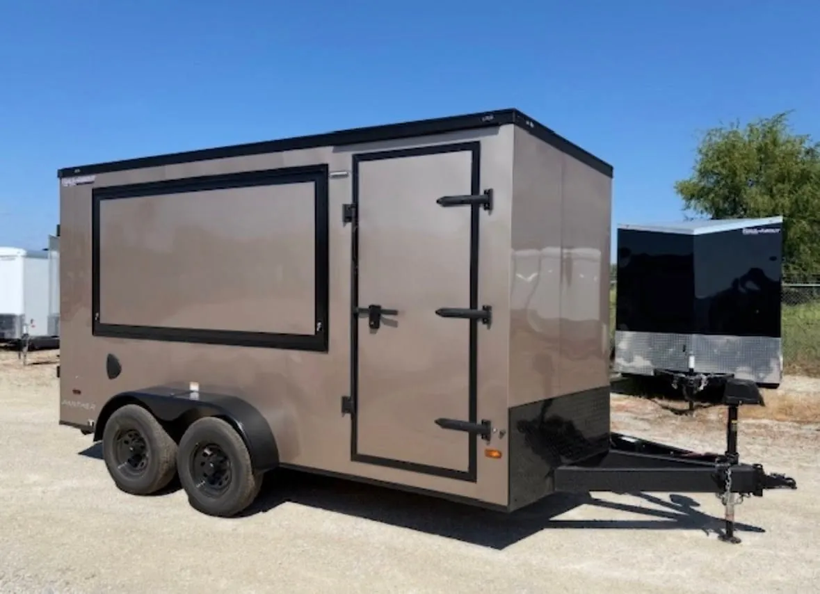 Haul-About enclosed trailer with a concession window, black-out trim and a side door, ready for a wrap.